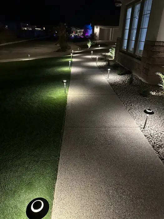 Artificial grass from Verde Valley Turf with pathway lights at night